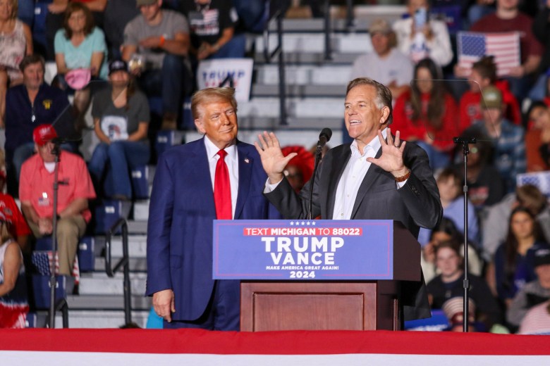 Mike Rogers on stage with Donald Trump. 