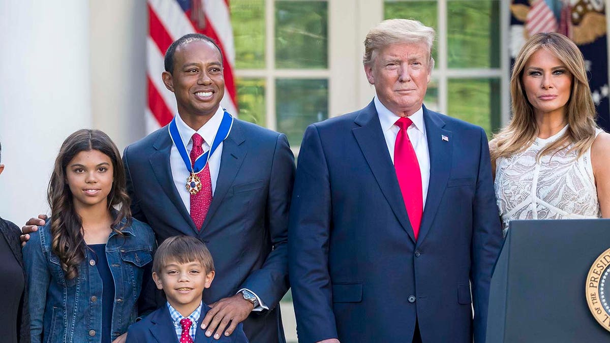 Tiger Woods posing with son Charlie Axel Woods, daughter Sam Alexis Woods, President Donald Trump, and first lady Melania Trump in the White House Rose Garden