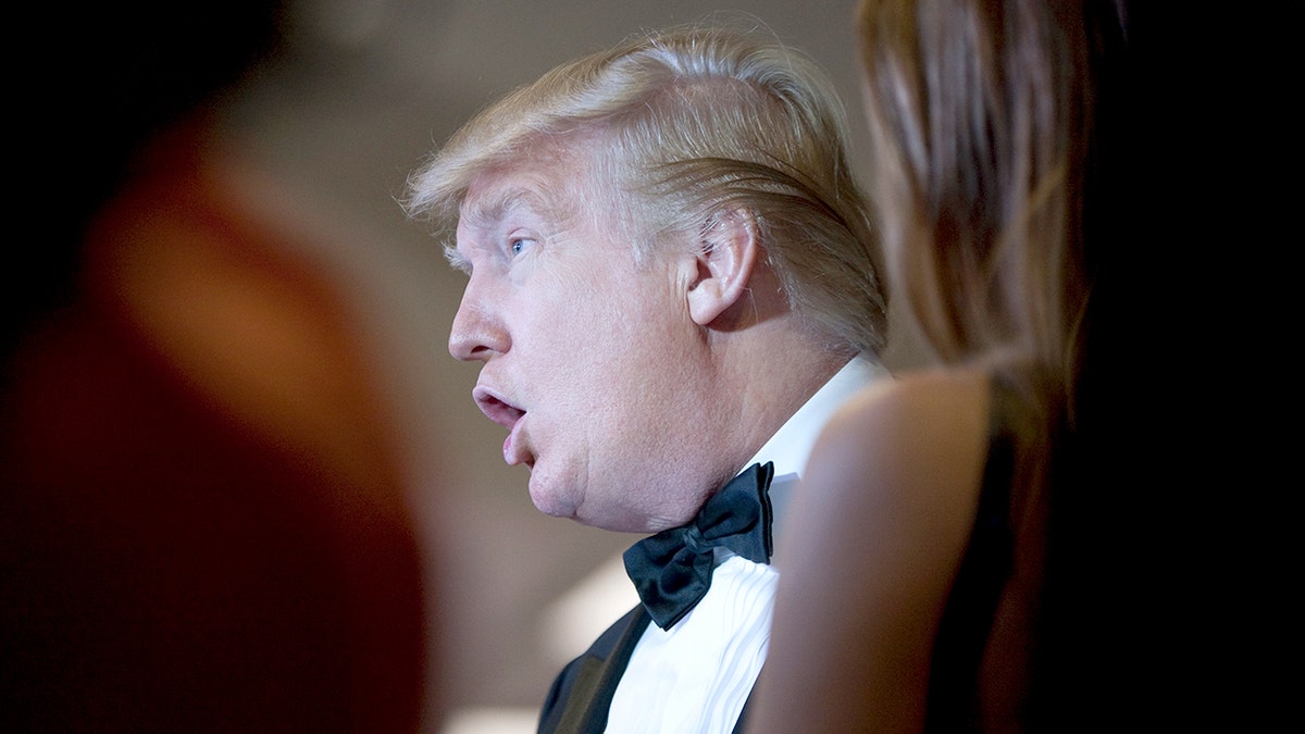 Donald Trump talking with guests at the White House Correspondents' Association dinner in Washington, D.C.