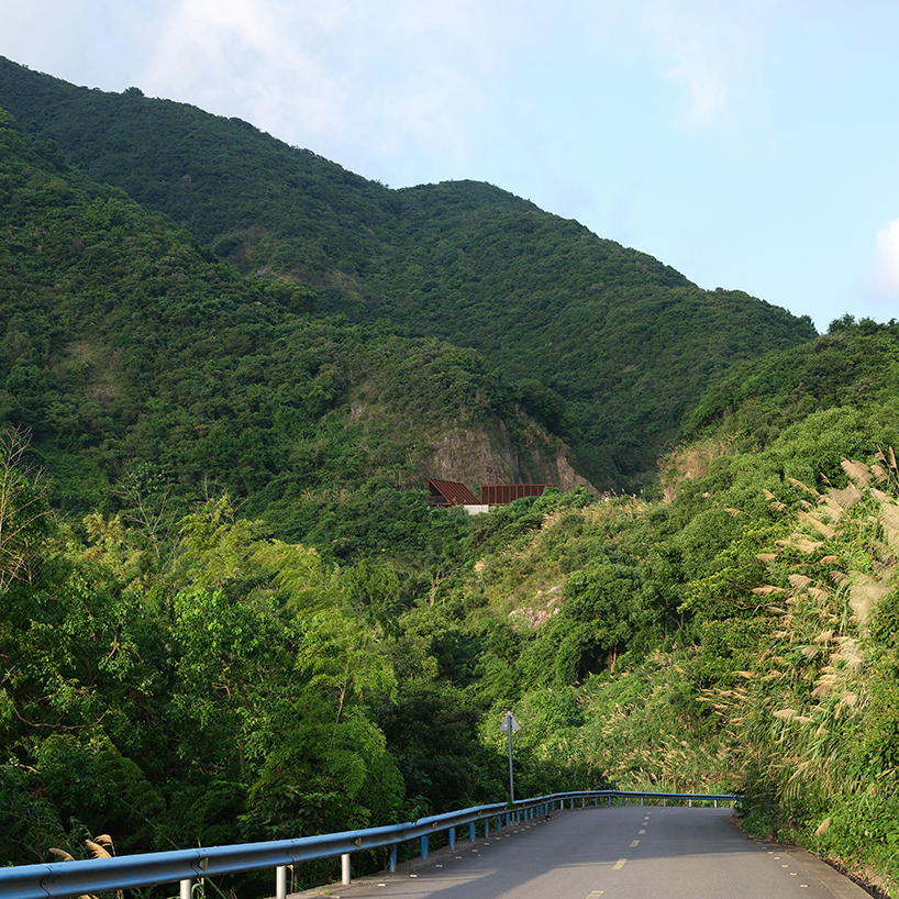 corten-clad twin pavilions frame shifting sea views along chinese coastal valley - 2