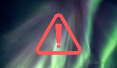ribbons of green light streak across the sky as an aurora show takes hold. In the foreground is a vector graphic of a warning/alert sign with an exclamation mark inside a triangle.