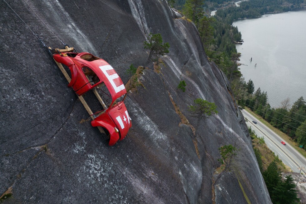 Car shell suspended on rock face above British Columbia highway in apparent prank