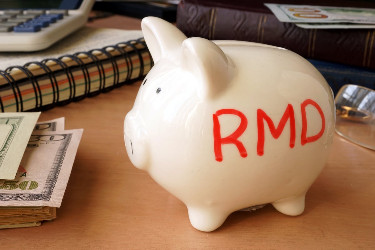 A white piggy bank with RMD written on it.