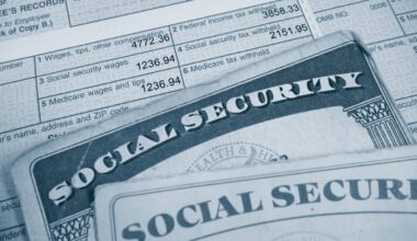 Two Social Security cards on top of a tax form.