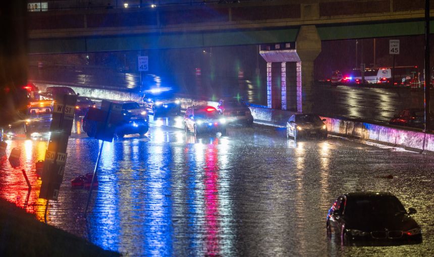 Emergency responders rescue stranded motorists after heavy rains flooded Milwaukee's Brewers Blvd. Wednesday.