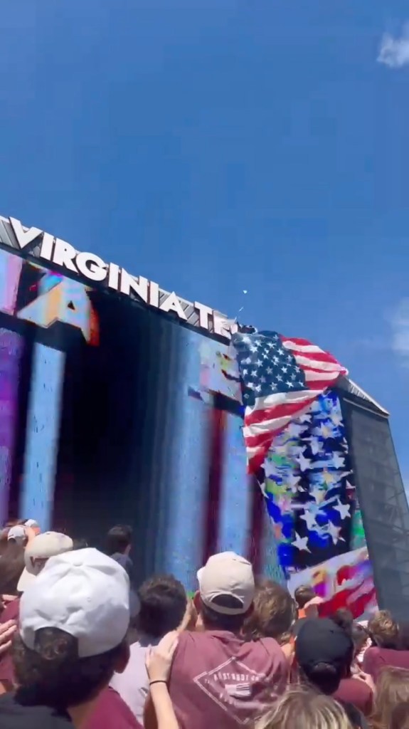 An American flag tangled on the "Virginia Tech" scoreboard at a spring game.