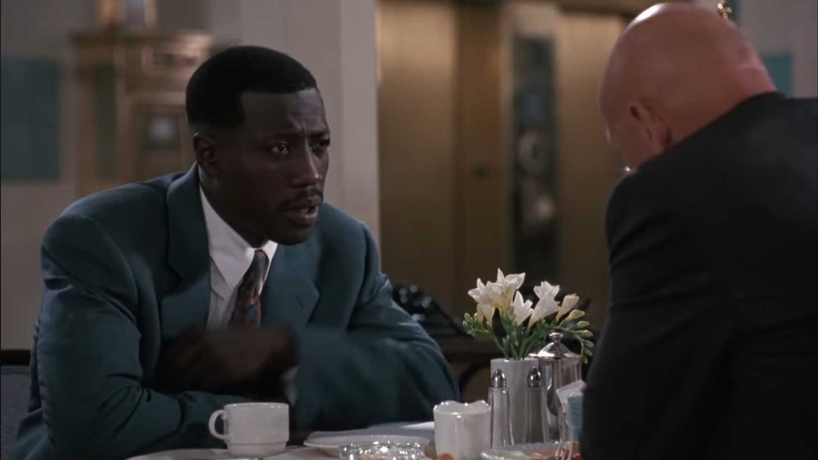 Wesley Snipes as Jimmy Mercer looking frustrated at a table in Boiling Point