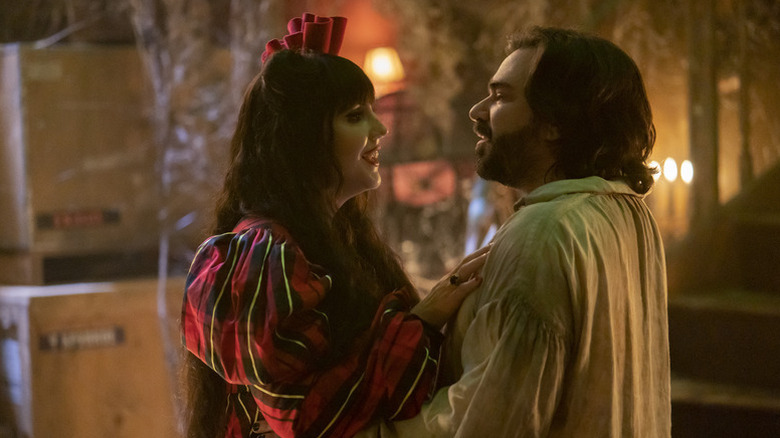 Nadja (Natasia Demetriou) smiles as she touches Laszlo Cravensworth (Matt Berry) in What We Do in the Shadows