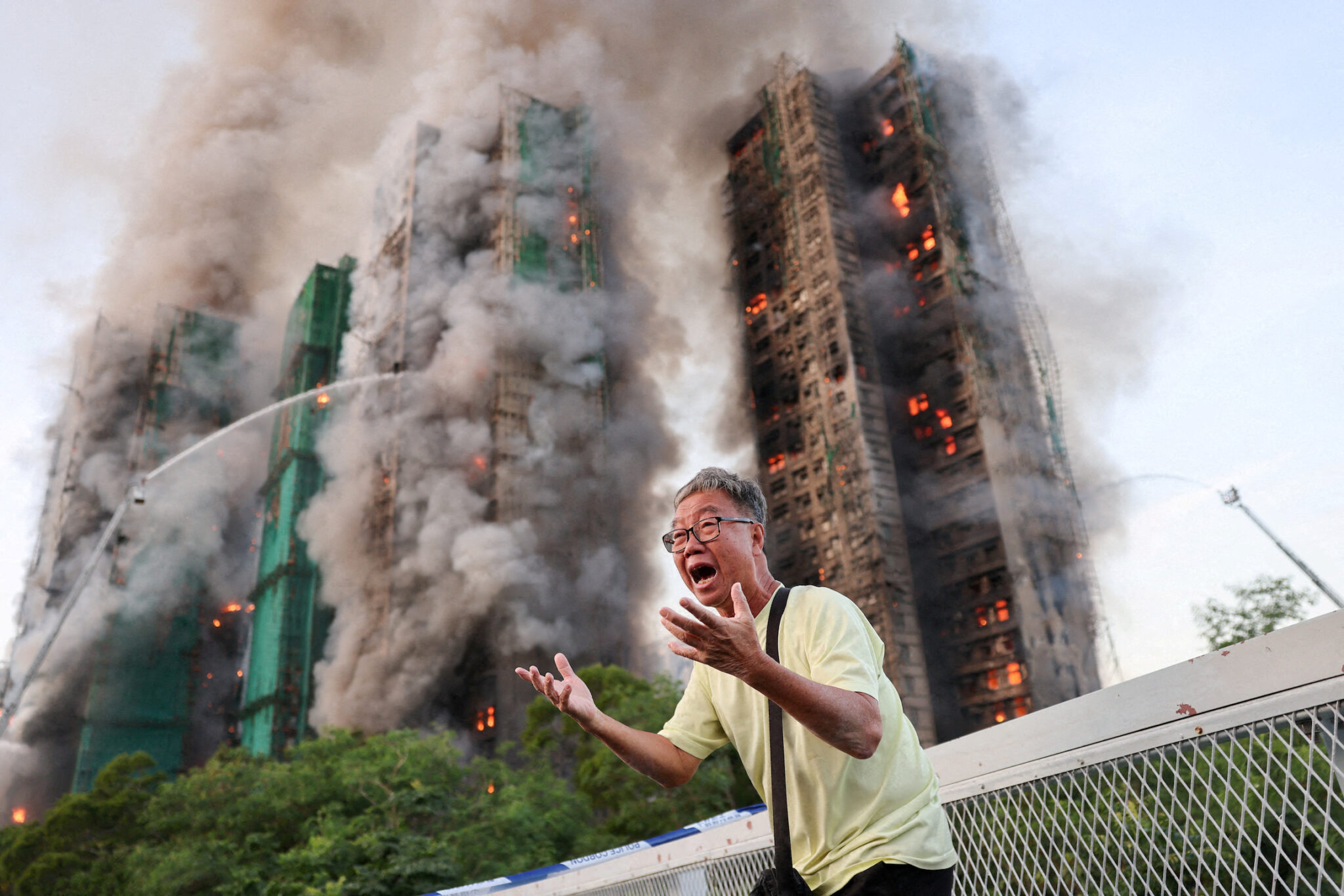 Tyrone Siu, “A Desperate Plea,” for Reuters. Mr. Wong cries out in anguish as fire engulfs the Tai Po housing complex he calls home. Moments earlier, he phoned his wife, who was trapped in the building, and they exchanged what would be their final words. Hong Kong, November 26, 2025.