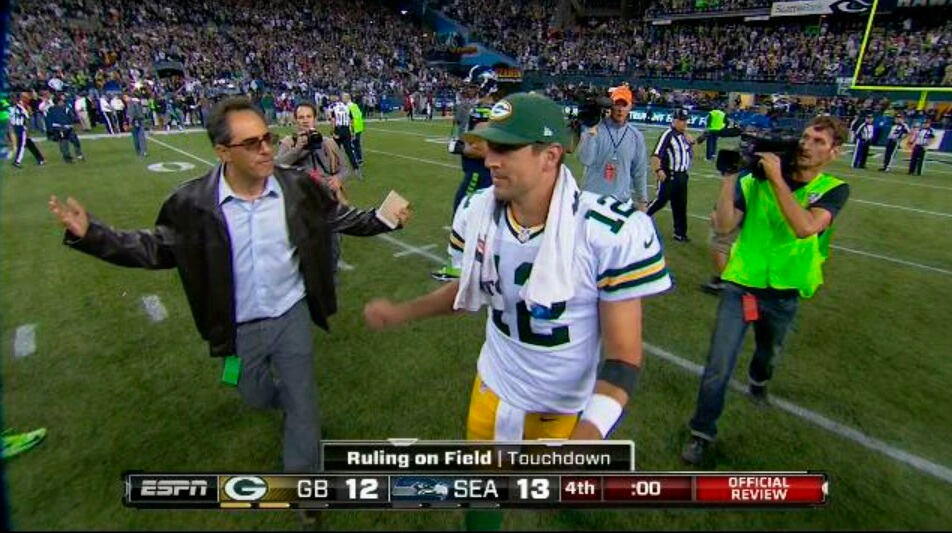 Writer Mike Silver approaches Aaron Rodgers on the field after the ending of a 2012 Packers-Seahawks game.