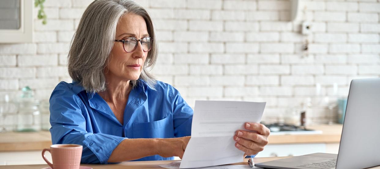 A middle-aged woman reviewing her finances