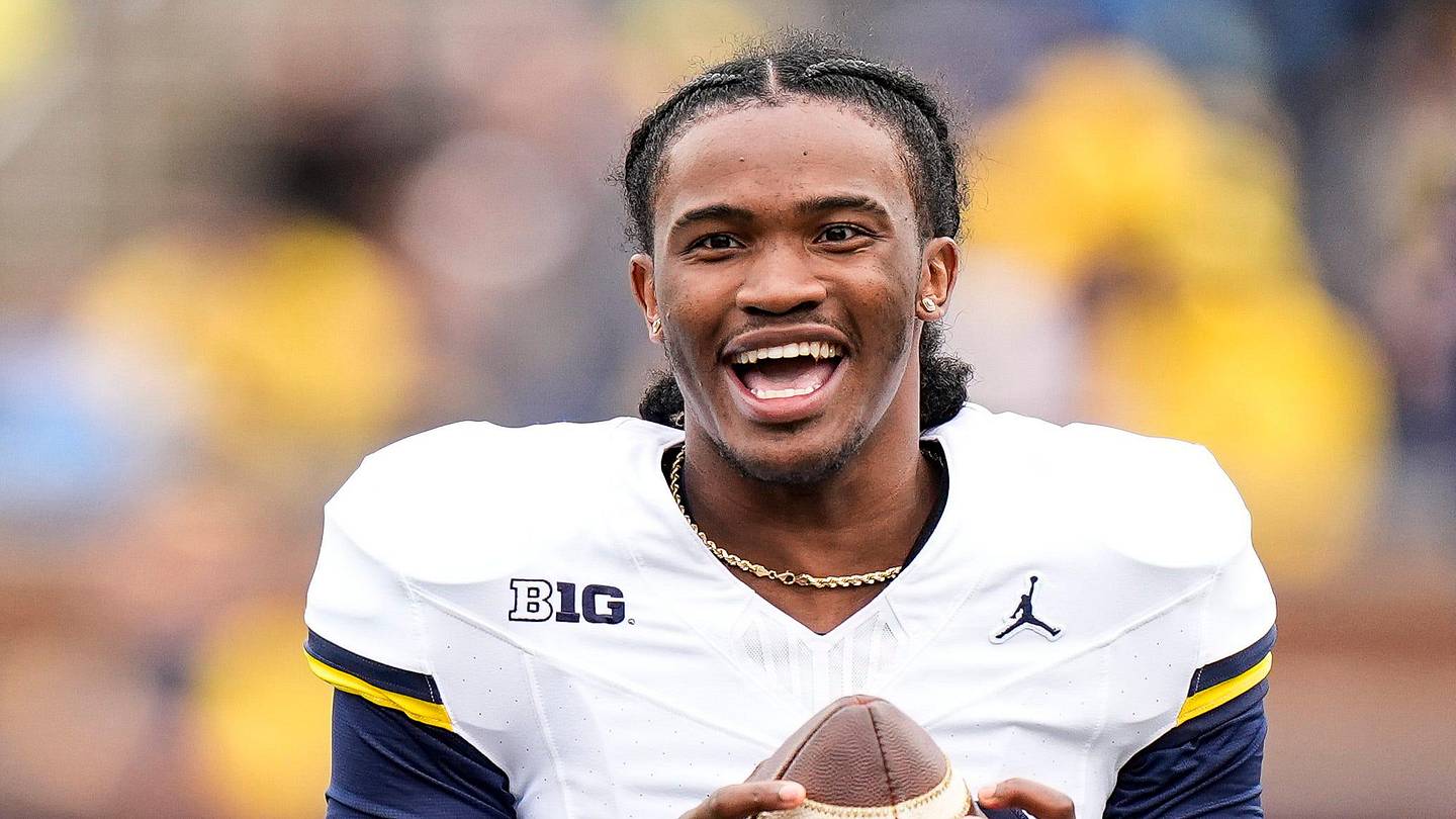 Michigan quarterback Bryce Underwood (19) shares a laughter with running back Jordan Marshall (23), left, during the spring game at Michigan Stadium in Ann Arbor on Saturday, April 18, 2026.