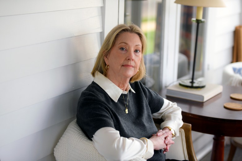A portrait of a woman sitting at home.