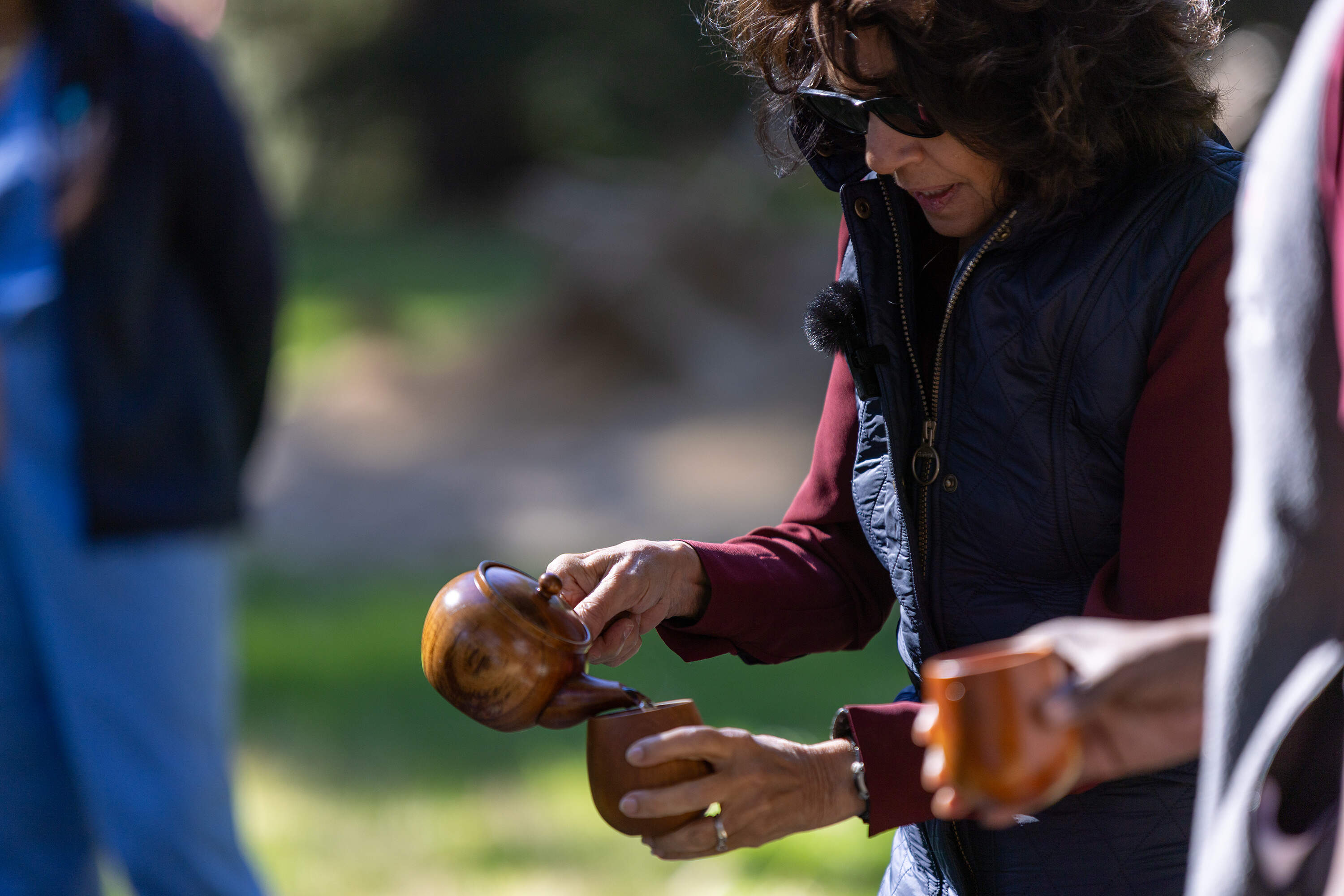 Dr Susan Abookire serves birch tea to close a forest therapy session at Harvard's Arnold Arboretum. (Jesse Costa/WBUR)
