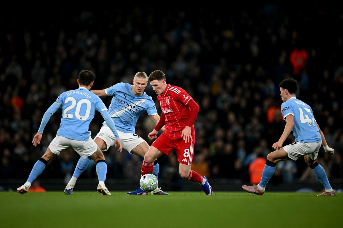 Nottingham Forest's English midfielder #08 Elliot Anderson runs with the ball whilst under pressure from Manchester City's Portuguese midfielder #20 Bernardo Silva (L) Manchester City's Norwegian striker #09 Erling Haaland and Manchester City's English midfielder #47 Phil Foden (R) during the English Premier League football match between Manchester City and Nottingham Forest at the Etihad Stadium in Manchester, north west England, on March 4, 2026.