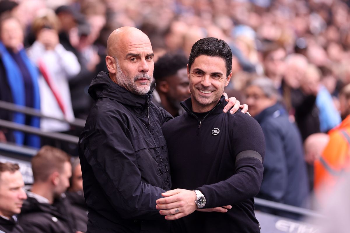 Pep Guardiola, Manager of Manchester City, and Mikel Arteta, Manager of Arsenal, interact prior to the Premier League match between Manchester City and Arsenal at Etihad Stadium