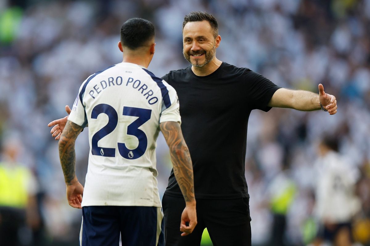 Roberto De Zerbi and Pedro Porro of Tottenham Hotspur celebrate at full time