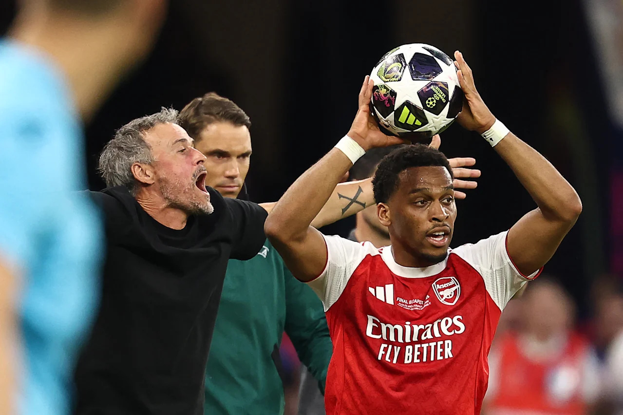 Paris Saint-Germain's Spanish head coach Luis Enrique (L) reacts next to Arsenal's Dutch defender #12 Jurrien Timber during the UEFA Champions League final football match between Paris Saint-Germain (PSG) and Arsenal FC at the Puskas Arena in Budapest on May 30, 2026. (Photo by FRANCK FIFE / AFP via Getty Images)