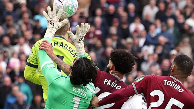 Arsenal goalkeeper David Raya is fouled by West Ham's Pablo and Todibo