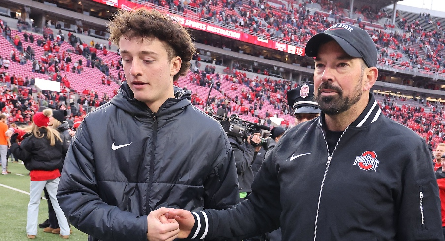 Nov 23, 2024; Columbus, Ohio, USA; Ohio State Buckeyes head coach Ryan Day celebrates with his son RJ Day (left) following the win against the Indiana Hoosiers at Ohio Stadium. Mandatory Credit: Joseph Maiorana-Imagn Images