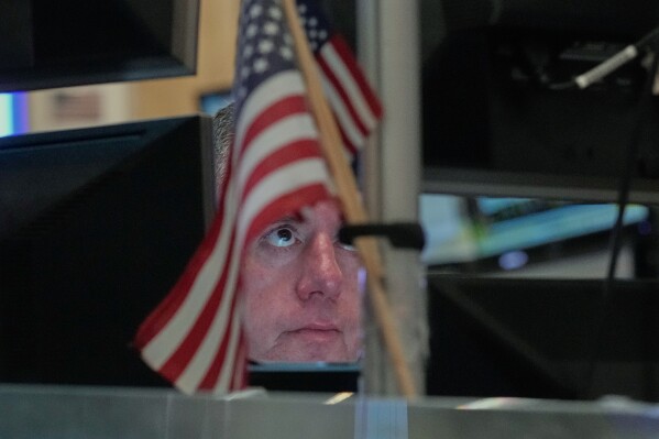 Trader Justin Flinn works on the floor of the New York Stock Exchange, Thursday, April 23, 2026. (AP Photo/Richard Drew, File)
