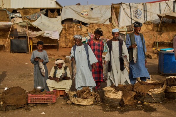 Fish vendors wait for customers at a market in Omdurman, on the outskirts of Khartoum, Sudan, Sunday, April 26, 2026. (AP Photo/Bernat Armangue, File)