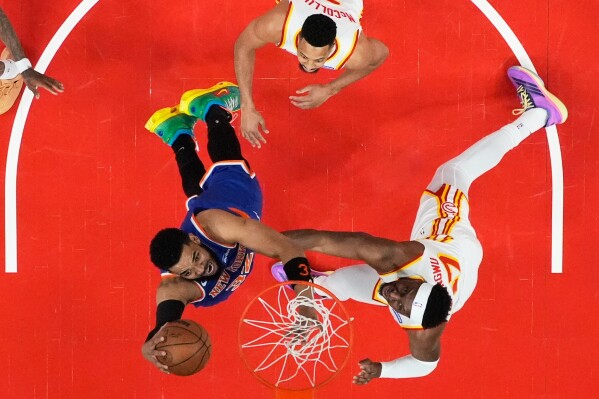 New York Knicks center Karl-Anthony Towns (32) shoots against Atlanta Hawks forward Onyeka Okongwu (17) during the first half of Game 4 in a first-round NBA playoffs basketball series Saturday, April 25, 2026, in Atlanta. (AP Photo/Brynn Anderson, File)