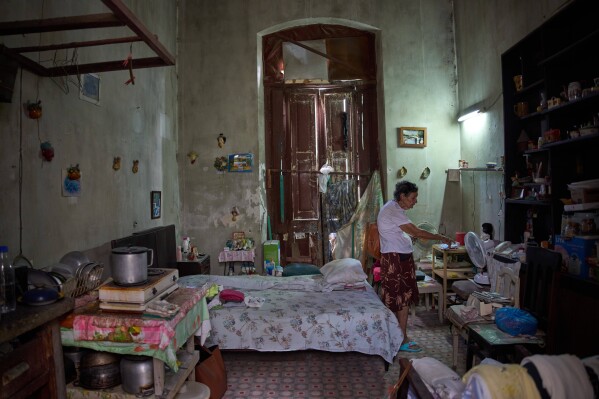 Mercedes Lopez Rey, 83, stands in her one-room apartment in Old Havana, Cuba, Friday, April 10, 2026. (AP Photo/Ramon Espinosa, File)