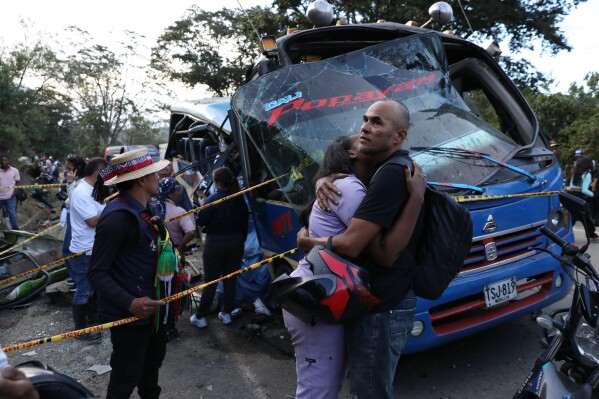 Relatives of victims embrace in front of a bus hit by an explosive device on the Pan-American Highway in Cajibio, Colombia, Saturday, April 25, 2026, after an attack blamed by authorities on dissident groups of the former FARC rebels killed at least a dozen people. (AP Photo/Santiago Saldarriaga, File)