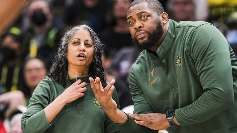 Seatte Storm head coach Sonia Raman confers with assistant coach...