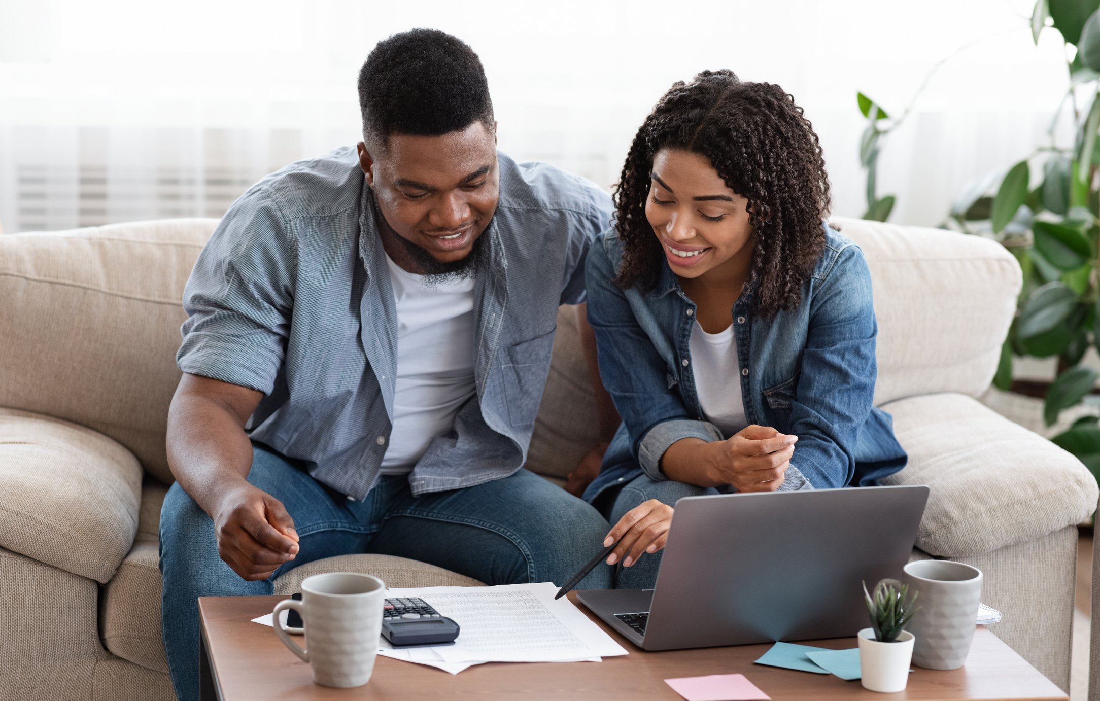 Smiling couple discussing documents together.