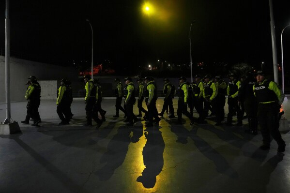 Police assemble ahead of nighttime curfew patrols as part of a government crackdown on crime in Quito, Ecuador, Sunday, May 3, 2026. (AP Photo/Dolores Ochoa)