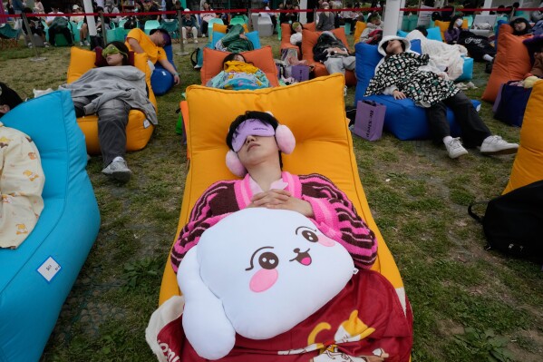Participants take a nap during the 2026 Hangang Nap Competition at Yeouido Hangang Park in Seoul, South Korea, Saturday, May 2, 2026. (AP Photo/Ahn Young-joon)