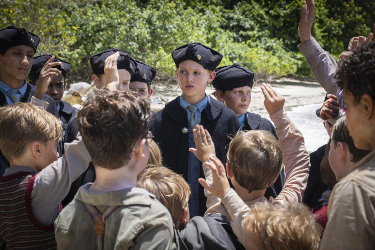 Jack (Lox Pratt), center, is a choir boy who declares himself "head hunter."