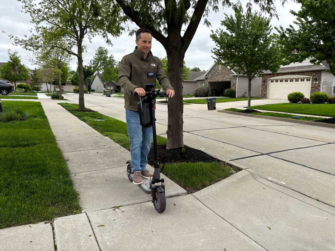Indiana state Sen. Spencer Deery rides his electric scooter to canvass neighborhoods in his districts ahead on April 28 of Indiana's primary election.