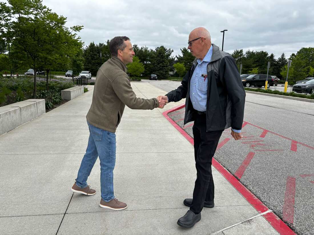 Outside a polling place in West Lafayette, Ind., Republican state Sen. Spencer Deery greets voters arriving for early voting on April 28. Deery is a Republican incumbent President Trump has targeted after he opposed the president's redistricting push in Indiana.