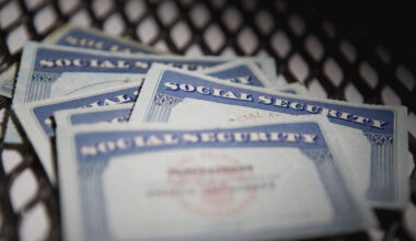 american culture, authority, chain-link fence, close-up, color image, group of objects, ideas, identity, indoors, nobody, photography, protection, safety, security, selective focus, social security card, text, western script, capital letter, horizontal