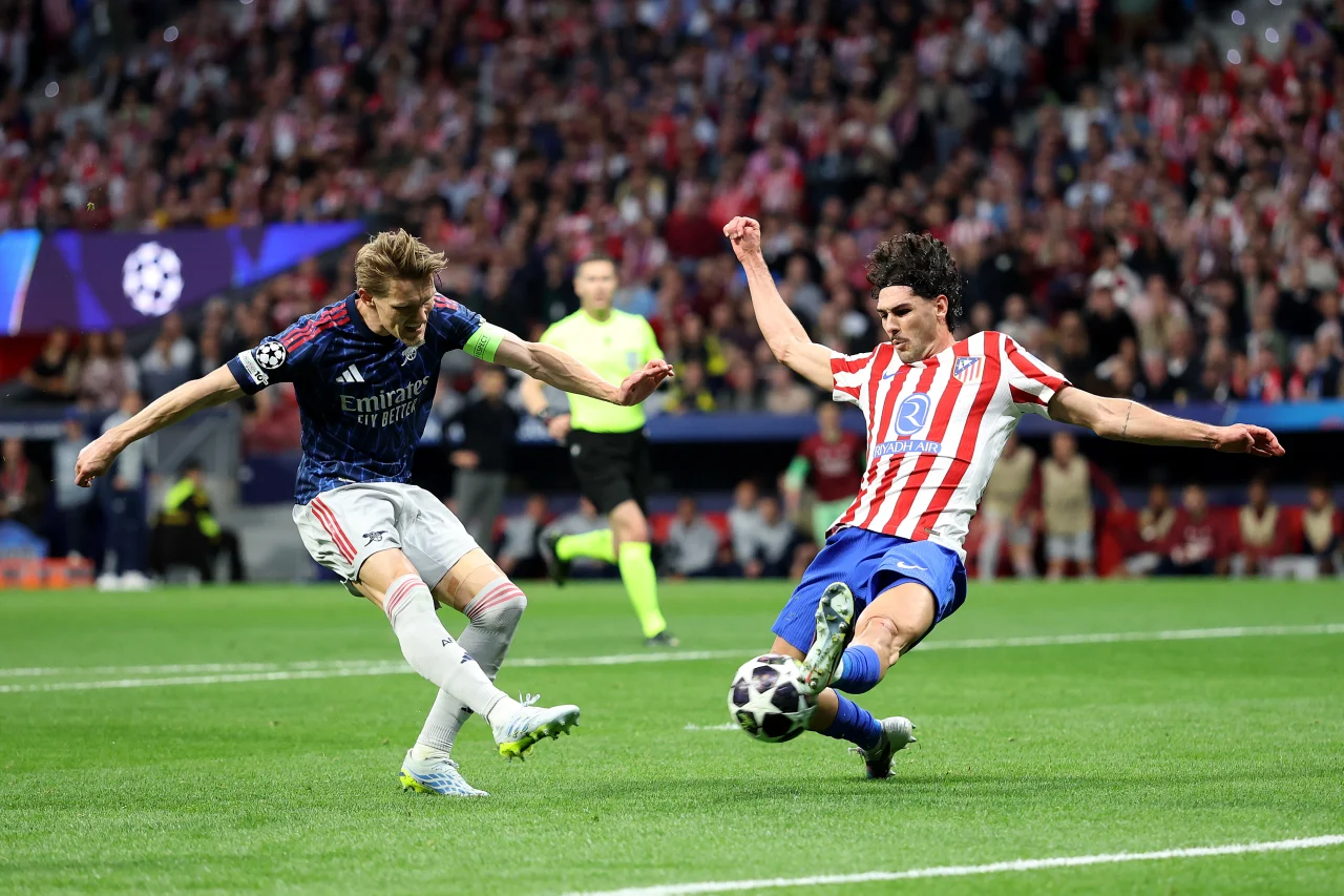 Arsenal's Martin Ødegaard has a shot blocked by Atlético Madrid's Johnny Cardoso during last week's match in Spain.