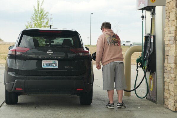 A motorist fills up the tank of a utility vehicle at a pump at a Buc-ee's gasoline stop Thursday, April 30, 2026, in Johnstown, Colo. (AP Photo/David Zalubowski)