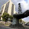 A large sculpture of a hand holding an oil drilling rig stands outside the state-run oil company Petroleos de Venezuela S.A. (PDVSA) in Caracas, Venezuela, on February 26, 2025.