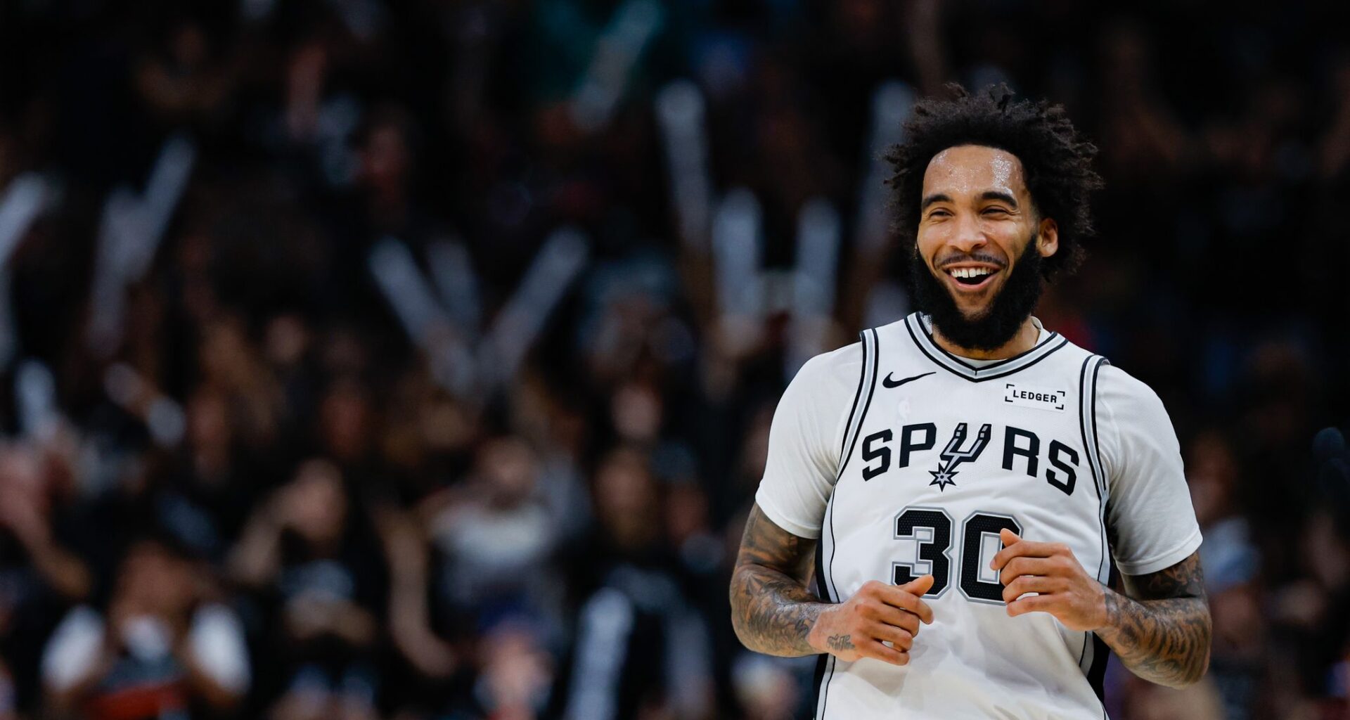 Julian Champagnie celebrating downtown after Spurs beat Blazers