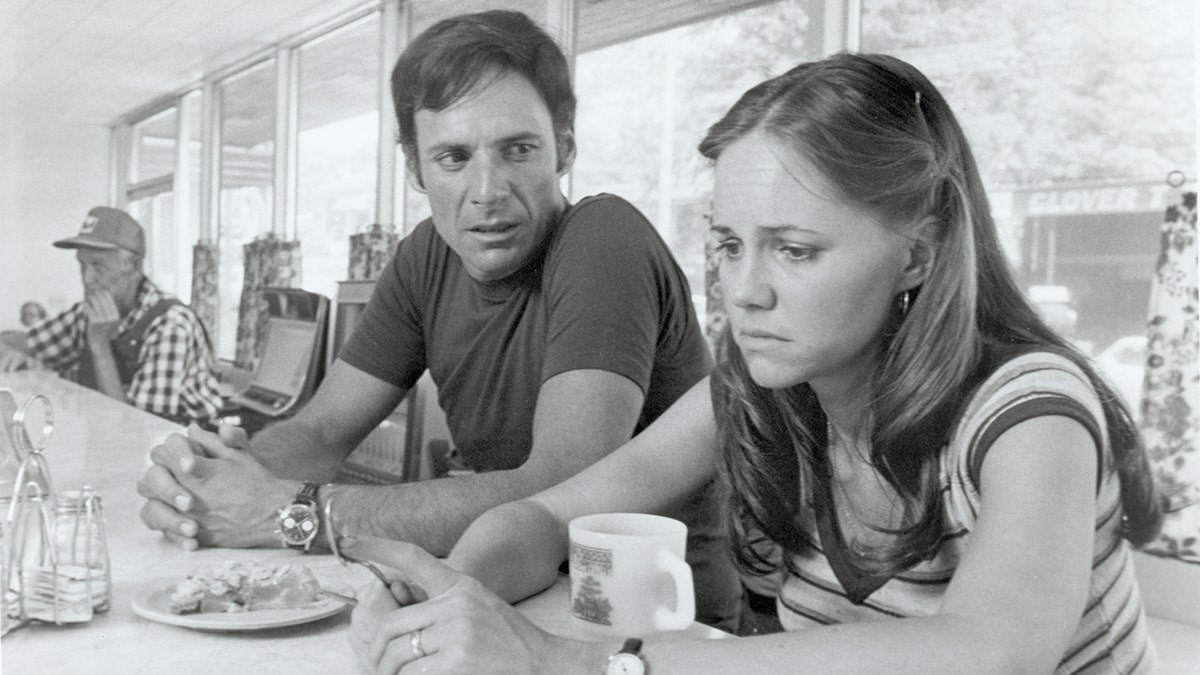 Actress Sally Field sitting in a diner with actor Ron Leibman in a movie scene