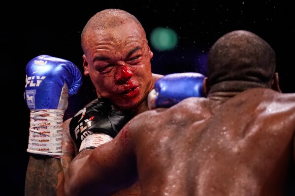 Britain's Daniel Dubois, right, lands a blow on Britain's Fabio Wardley during their WBO World Heavyweight boxing title bout in Manchester, Saturday, May 9, 2026. (AP Photo/Dave Thompson)