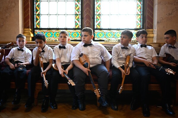 Youth orchestra wait to perform during the inaugural session of Hungary's parliament in Budapest, Hungary, Saturday, May 9, 2026. (AP Photo/Denes Erdos)