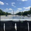 Workers paint a corner of the reflecting pool blue on Monday morning.