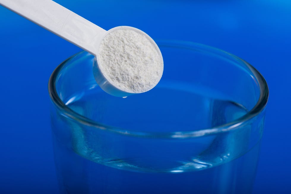 Sport supplement, creatine, hmb, bcaa, amino acid or vitamin - mesure with powder over a glass of water. Sport nutrition concept. sport supplement, creatine,