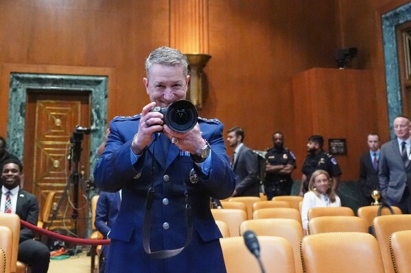 Chairman of the Joint Chiefs of Staff Gen. Dan Caine takes a photo before a Senate Appropriations subcommittee on defense hearing on the budget request for the Department of Defense, Tuesday, May 12, 2026, in Washington. (AP Photo/Alex Brandon)