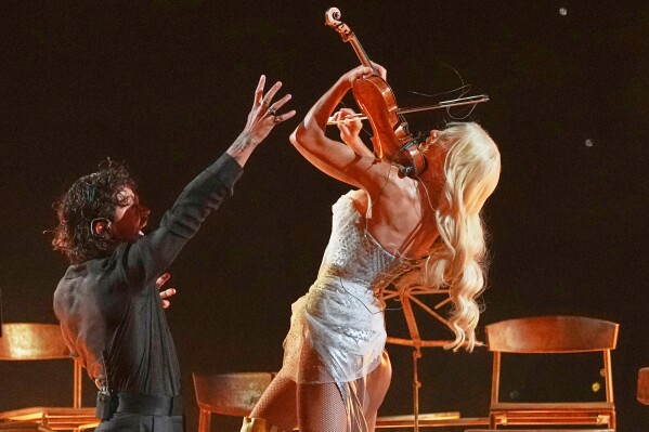 Linda Lampenius and Pete Parkkonen from Finland perform the song "Liekinheitin" during the first semifinal of the 70th Eurovision Song Contest in Vienna, Austria, Tuesday, May 12, 2026. (AP Photo/Martin Meissner)
