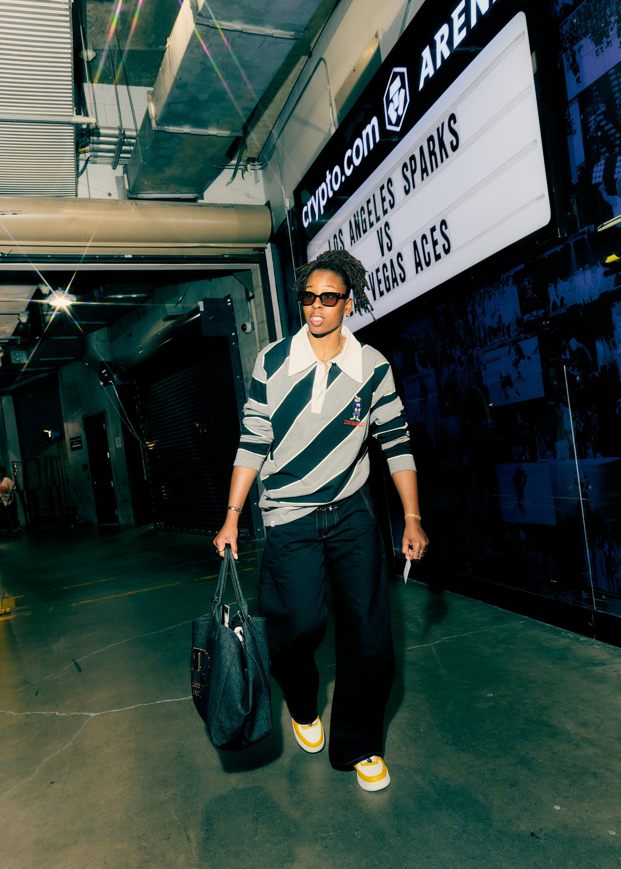 Ariel Atkins wears Zara pants, Charles Keith top, Bape shoes and Ganni bag.