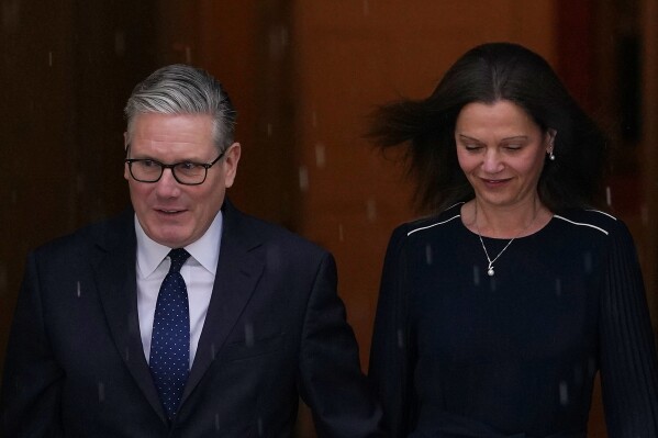Britain's Prime Minister Keir Starmer and wife Victoria leave 10 Downing Street to attend the State Opening of Parliament at the Houses of Parliament in London, Wednesday, May 13, 2026.(AP Photo/Alberto Pezzali)